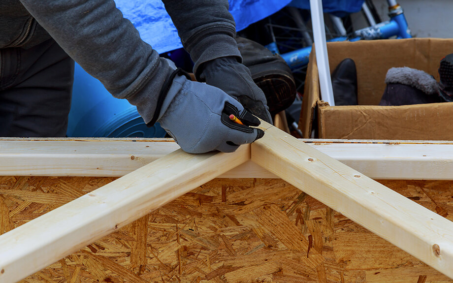 A worker measuring timber